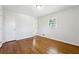 Well-lit bedroom, hardwood floors and access to bathroom at 6467 Joanna St, Lithia Springs, GA 30122