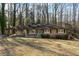 Ranch house with carport and large backyard nestled in a wooded area at 6467 Joanna St, Lithia Springs, GA 30122