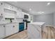Bright kitchen features white cabinets, quartz counters, and a modern, stainless steel appliance at 6467 Joanna St, Lithia Springs, GA 30122