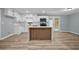 Bright kitchen features white cabinets, quartz counters, and a modern, stainless steel appliance at 6467 Joanna St, Lithia Springs, GA 30122