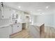 Modern kitchen features white cabinets, quartz countertops, and an island at 6467 Joanna St, Lithia Springs, GA 30122