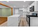 Bright kitchen features white cabinets, quartz counters, and a modern, stainless steel appliance at 6467 Joanna St, Lithia Springs, GA 30122
