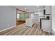 Bright kitchen featuring white cabinets, stainless steel appliances, sleek countertops, and a waterfall island at 6467 Joanna St, Lithia Springs, GA 30122