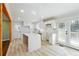 Bright kitchen features white cabinets, quartz counters and island, subway tile backsplash, and stainless sink at 6467 Joanna St, Lithia Springs, GA 30122