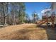 Large backyard with deck and wooded area at 1956 Spencer Oaks Ln, Lithonia, GA 30058
