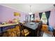 Dining room with table and chairs, purple walls, and hardwood floors at 1956 Spencer Oaks Ln, Lithonia, GA 30058