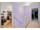 Upstairs hallway with light purple walls and white railing at 1956 Spencer Oaks Ln, Lithonia, GA 30058