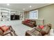 Finished basement Gathering room with built-in shelving and a large TV at 3323 Glen Devon Ln, Berkeley Lake, GA 30096