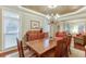 Formal dining room with hardwood floors and chandelier at 3323 Glen Devon Ln, Berkeley Lake, GA 30096