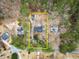 An aerial view of a wooded property with several structures and mature trees, showing property lines at 3570 Knoll Crest Trl, Buford, GA 30519