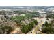 Aerial view of house and surrounding neighborhood, showing wooded area and nearby roads at 3570 Knoll Crest Trl, Buford, GA 30519