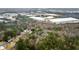 Aerial view of a residential area near commercial buildings and a wooded area at 3570 Knoll Crest Trl, Buford, GA 30519