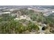 Aerial view of a residential neighborhood surrounded by lush greenery at 3570 Knoll Crest Trl, Buford, GA 30519