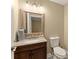 Updated bathroom with a vanity and decorative mirror at 3570 Knoll Crest Trl, Buford, GA 30519