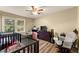 Well-lit bedroom with wood floors and a view of the backyard at 3570 Knoll Crest Trl, Buford, GA 30519
