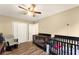 Bright bedroom with two cribs and a ceiling fan at 3570 Knoll Crest Trl, Buford, GA 30519