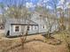 Gray house with white shutters, landscaping, and a stone retaining wall at 3570 Knoll Crest Trl, Buford, GA 30519