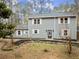 Two-story gray house with white shutters, stone accents, and landscaping at 3570 Knoll Crest Trl, Buford, GA 30519