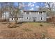 Two story gray house with white shutters and stone landscaping at 3570 Knoll Crest Trl, Buford, GA 30519