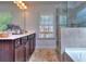 Bathroom with double vanity, soaking tub, and shower at 11118 Benton Woods Dr, Covington, GA 30014