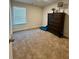 Bedroom with brown carpet, a window, dresser and a blue blanket at 11118 Benton Woods Dr, Covington, GA 30014