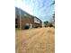 Exterior elevation view of the building with brown grass and blue sky at 11118 Benton Woods Dr, Covington, GA 30014