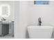 Elegant bathroom featuring a freestanding bathtub and gray vanity at 2195 Springdale Sw Rd, Atlanta, GA 30315