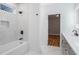 Bathroom with a bathtub, shower, gray vanity, and marble tile at 2195 Springdale Sw Rd, Atlanta, GA 30315