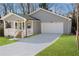 Gray house with white garage door, front porch, and landscaped lawn at 2195 Springdale Sw Rd, Atlanta, GA 30315