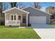 Gray house with a blue door, porch, and garage at 2195 Springdale Sw Rd, Atlanta, GA 30315