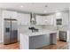 Spacious kitchen featuring white cabinets, a large island, and marble countertops at 2195 Springdale Sw Rd, Atlanta, GA 30315