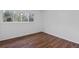 Bright bedroom with wood-look flooring and large window at 3242 Henderson Mill Rd # 3, Atlanta, GA 30341