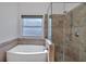 Bathroom with a walk-in shower, soaking tub, and tile flooring at 2124 Berryhill Se Cir, Smyrna, GA 30082