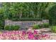 Stone entrance sign of Paces Lake community, landscaped with flowering plants at 2124 Berryhill Se Cir, Smyrna, GA 30082