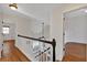 Upstairs hallway with hardwood floors and access to bedrooms at 2124 Berryhill Se Cir, Smyrna, GA 30082