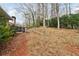 Wooded backyard with sloped terrain and stone wall at 2481 Brookdale Dr, Atlanta, GA 30345