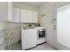 Functional laundry room with washer, dryer, and ample shelving at 2481 Brookdale Dr, Atlanta, GA 30345