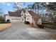 House exterior showcasing a three-car garage and driveway at 3210 Garmon Oak Trl, Lawrenceville, GA 30044