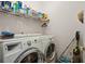 Laundry room with washer, dryer, and shelving at 3210 Garmon Oak Trl, Lawrenceville, GA 30044