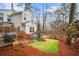 Charming backyard with a grassy area, mature trees, and a patio at 1992 Walthall Nw Dr, Atlanta, GA 30318