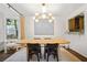 Elegant dining room with a large wooden table and modern chandelier at 1992 Walthall Nw Dr, Atlanta, GA 30318