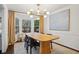 Bright dining room featuring a wooden table, chandelier, and large windows at 1992 Walthall Nw Dr, Atlanta, GA 30318