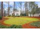 White two-story house with landscaped yard and trees at 1992 Walthall Nw Dr, Atlanta, GA 30318