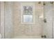 Large shower with marble tile and glass doors at 1992 Walthall Nw Dr, Atlanta, GA 30318