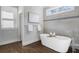 Main bathroom with soaking tub and hardwood floors at 2071 Howard Circle Ne, Atlanta, GA 30307