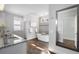 Main bathroom with soaking tub, double vanity, and hardwood floors at 2071 Howard Circle Ne, Atlanta, GA 30307