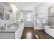 Main bathroom with double vanity, soaking tub and hardwood floor at 2071 Howard Circle Ne, Atlanta, GA 30307