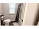 Full bathroom with tub shower, toilet, and window at 213 Cades Ct, Mcdonough, GA 30252