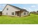 Exterior view of the backyard featuring a home with light siding, dark roof and a lush, green lawn at 3921 Brushy St, Powder Springs, GA 30127