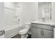 A bathroom with a combined shower and tub, modern vanity with sink, and a wood-look vinyl floor at 3921 Brushy St, Powder Springs, GA 30127